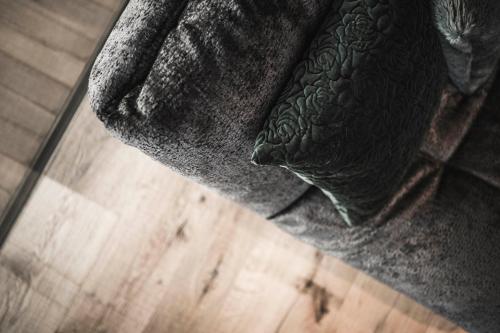 a close up of the corner of a bed with a blanket at Luxury Chalet Vilaiet in Ortisei