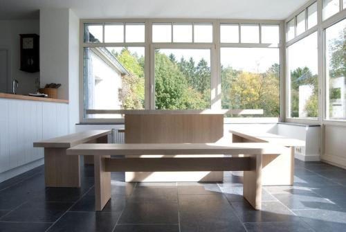 a large room with a bench in front of a window at Le Chaperon Villa in Tellin