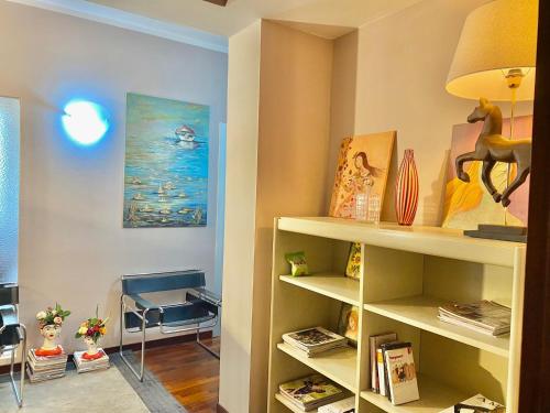 a room with shelves and a table and a lamp at Le Camere di Mara in Foligno