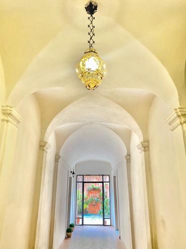 a chandelier hangs over a hallway in a house at Le Camere di Mara in Foligno