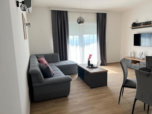 a living room with a couch and a table at Apartments HAS in Kotor