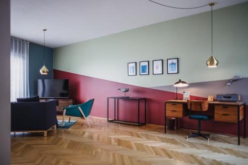 a living room with a desk and a tv at The Circus Apartments in Berlin