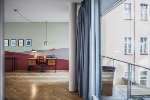 an empty room with a desk and a window at The Circus Apartments in Berlin