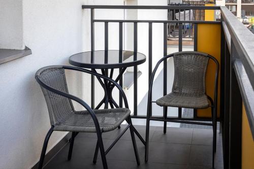 two chairs and a table on a balcony at Apartament LUX przy Pileckiego 34 in Biała Podlaska