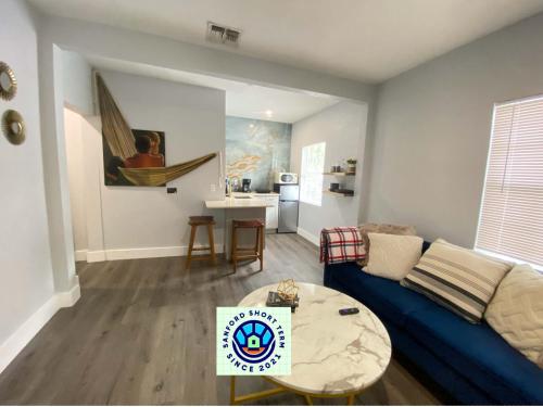 a living room with a blue couch and a table at Bella Breeze in Sanford