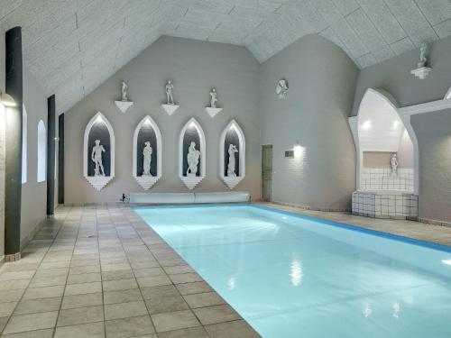 a large swimming pool in a building with an indoor swimming pool at 5 star holiday home in Spøttrup-By Traum in Spottrup