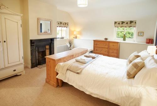 a bedroom with a large bed and a fireplace at The White House in Little Weighton