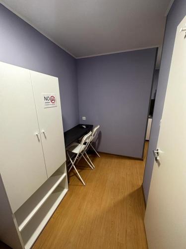 an empty room with a desk and a refrigerator at Klauzal19 Rooms in Budapest
