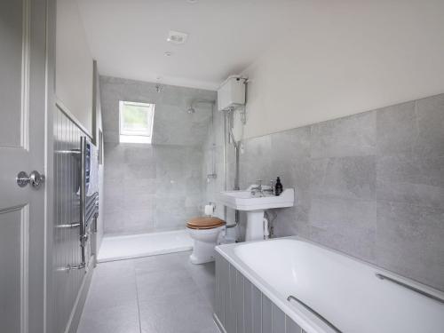 a bathroom with a tub and a toilet and a sink at Lassintullich House East Wing in Kinloch Rannoch