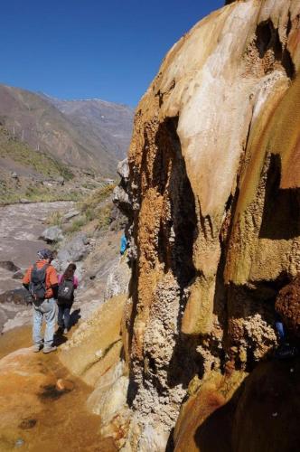 two people walking down a rocky mountain trail at Hostal Crisol in Lo Valdés