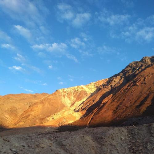 a brown mountain with a blue sky in the background at Hostal Crisol in Lo Valdés