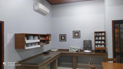 a kitchen with a table with a laptop on it at Hotel Mattes in Joinville