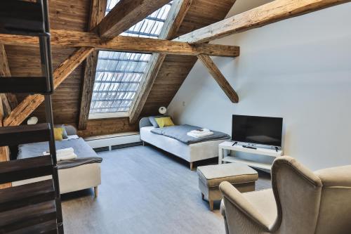 a living room with a couch and a tv at Just Jimramov in Jimramov