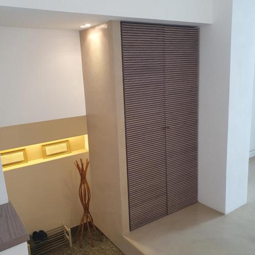 a room with a large glass door in a room at Gaia Suites - A due passi dal centro - Parcheggio privato in Turin