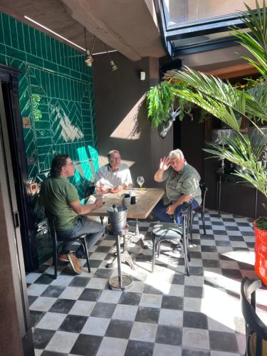 a group of men sitting at a table in a restaurant at La Piazzetta degli Artisti - Boutique B&B in Bossolasco