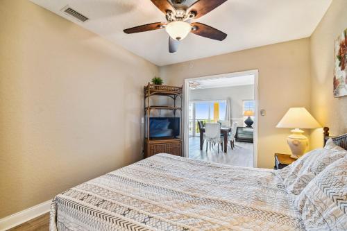 a bedroom with a bed and a ceiling fan at Treasure Island beach retreat in St. Pete Beach