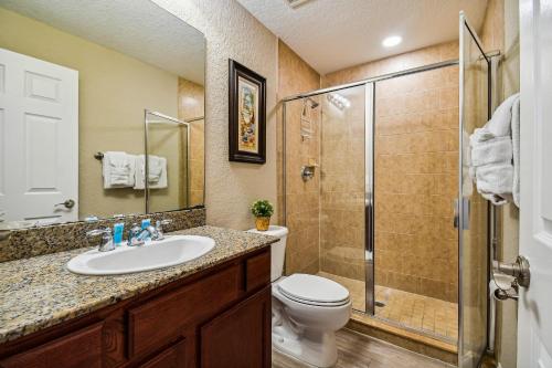 a bathroom with a toilet and a sink and a shower at Treasure Island beach retreat in St. Pete Beach