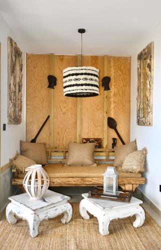 a living room with a couch and two tables at Les Hauteurs de Citronnelles in Case-Pilote