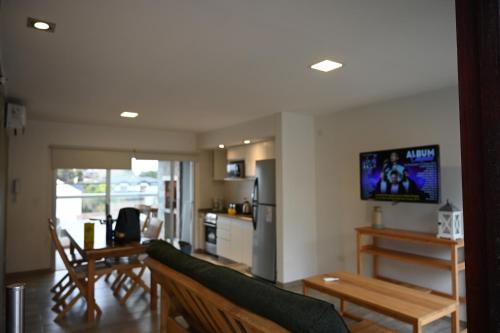 A television and/or entertainment centre at Costa Azul Rent Apartments