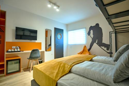 a bedroom with a bed with a painting on the wall at Ice Premium Apartments in Veszprém