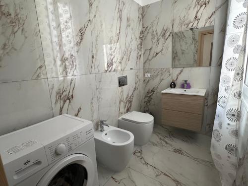 a white bathroom with a washing machine in it at CASA ANGELA Vista mare in Ventimiglia