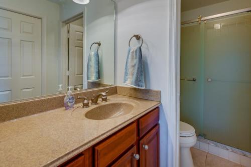 a bathroom with a sink and a mirror at Naples Condo with Pool Access - 3 Mi to Beaches! in Naples
