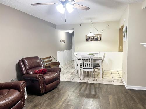 a living room with a couch and a chair and a table at The River Cottage in Pigeon Forge
