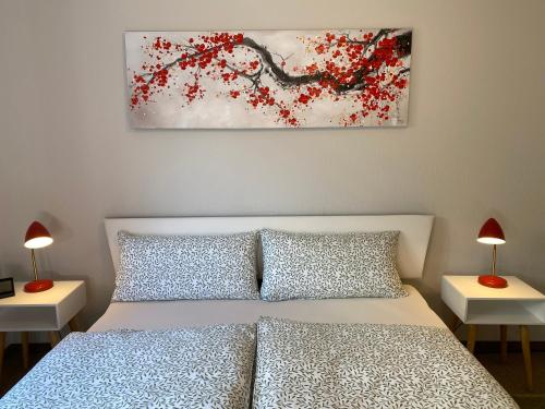 a bedroom with a bed and two tables with lamps at Appartement Am Weinberg in Radebeul