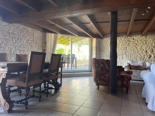 a bedroom with a bed and a table and chairs at Les Constellations, 8 gite complex, 53 people, marriage, birthday, etc in Doeuil-sur-le-Mignon