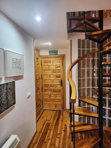 a room with a wooden staircase and a wine cellar at La casa sobre el rÍo in Cuenca