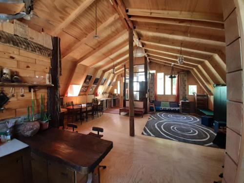 a large room with wooden ceilings and a living room at Hostal Crisol in Lo Valdés