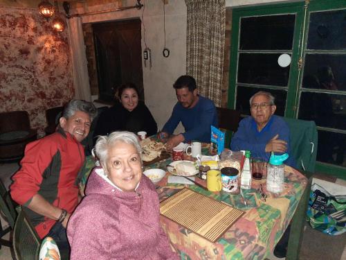 a group of people sitting around a table eating at Hostal Crisol in Lo Valdés