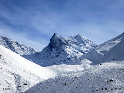 a snow covered mountain with a snow covered mountain at Hostal Crisol in Lo Valdés