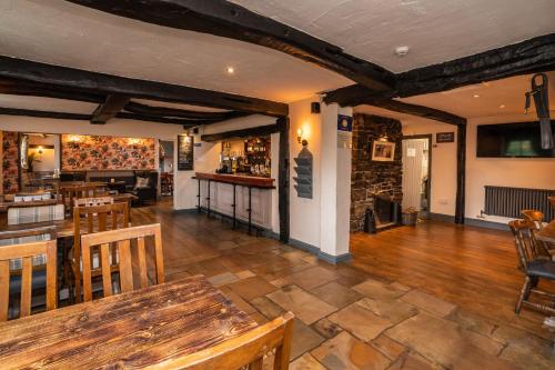 a restaurant with a table and chairs and a bar at The Strawbury Duck Inn in Darwen