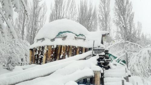 a yard covered in snow with a building at Hostal Crisol in Lo Valdés