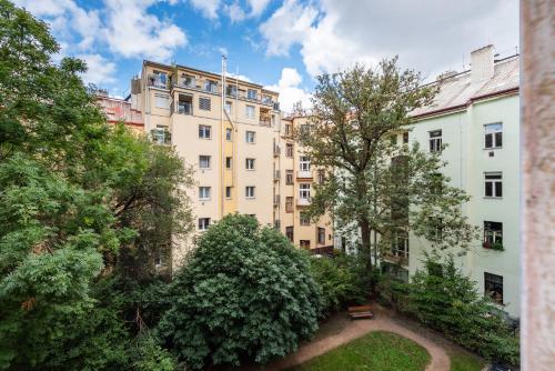 a group of buildings with trees and a park at Prague - Karlin Apartments in Prague