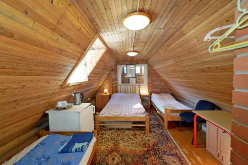 Habitación con 2 camas en una cabaña de madera en Skruzdėlynas, en Nida
