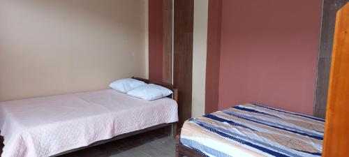 a room with two beds in a room at Villa Potokar in Tingo María