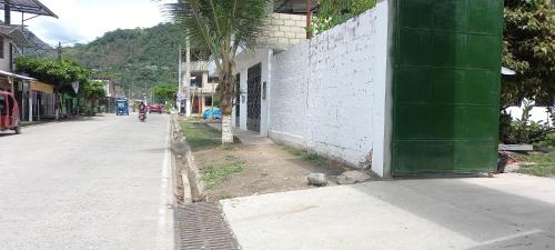 a building with a green door on the side of a street at Villa Potokar in Tingo María