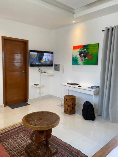 a room with a table and a desk in it at Les Residences de la Diaspora in Dakar