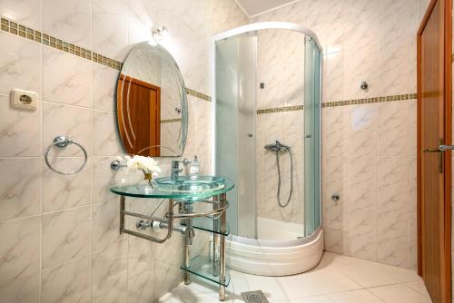 a bathroom with a glass sink and a shower at Villa StellaVita in Lozovac