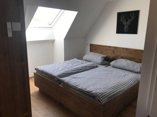 a bedroom with a bed in a room with a window at Ferienwohnung im Berghüttenstyle in Bad Wörishofen
