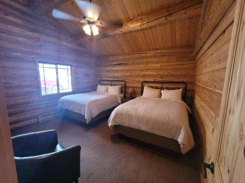 A bed or beds in a room at Roosevelt Hotel - Yellowstone