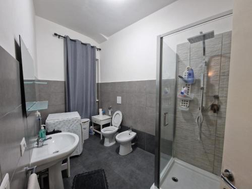 a bathroom with a shower and a toilet and a sink at CorneliaGuestHouse in Rome