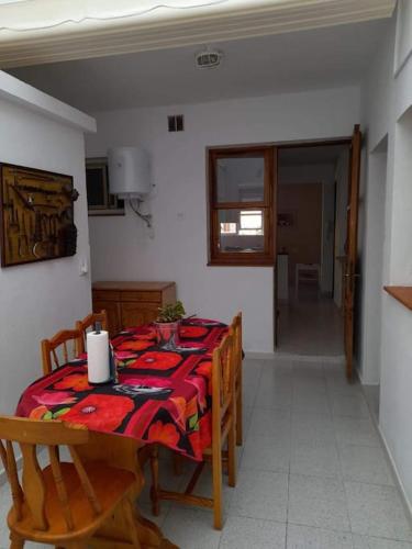 a dining room with a table and chairs with a tablecloth at El Rincon de Nina in La Laguna
