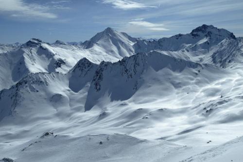 a snowy mountain range with snow covered mountains at Hotel Garni Alpenhof in Ischgl