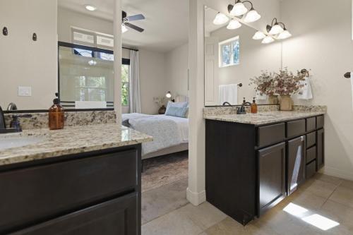 a bathroom with a double sink and a bedroom at The Sage Wood House in Flagstaff