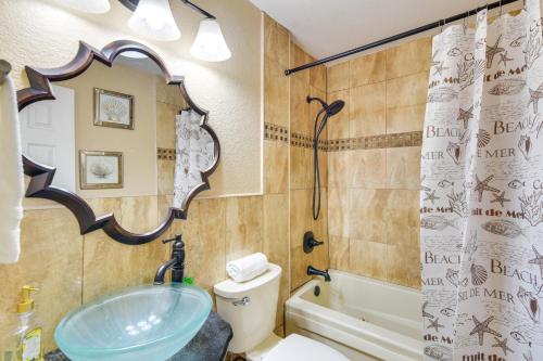 a bathroom with a sink and a toilet and a mirror at Opa-locka Townhome, 15 Mi to Miami Beach! in Opa-locka