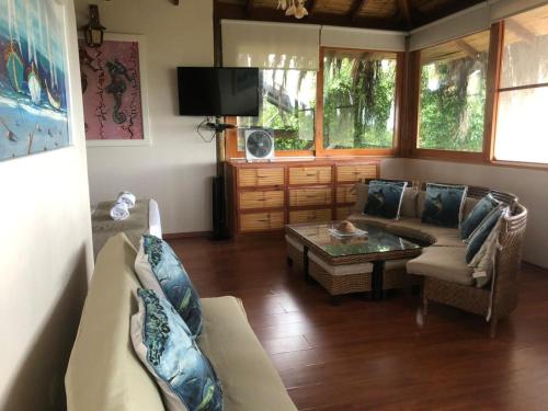 a living room with a couch and a coffee table at Aquamare Bungalows in Cruz de Pizarro