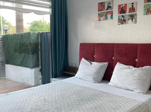 a bedroom with a large bed with a red headboard at Super Luks, Denize 100 Metre, Ruya Evi 2 in Marmaris